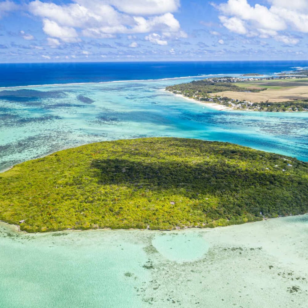 lush vegetation on ile aux aigrettes atoll in the turquoise lagoon, aerial view, pointe d'esny, mahebourg, indian ocean, mauritius